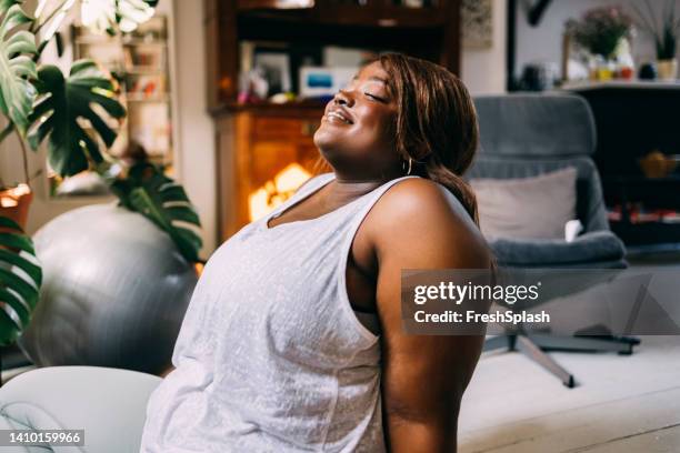 woman relaxing at home - black woman yoga stock pictures, royalty-free photos & images