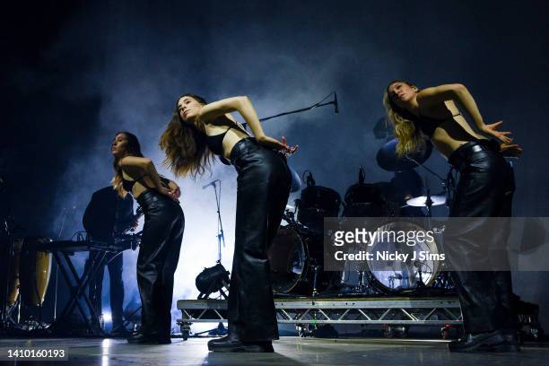 Alana Haim, Danielle Haim and Este Haim of HAIM perform at the O2 Arena on July 21, 2022 in London, England.