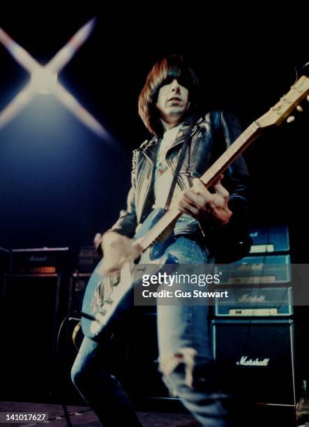 Johnny Ramone of The Ramones performs on stage at The Roundhouse, Camden, London, 4th July 1976. He plays a Mosrite guitar in front of a stack of...