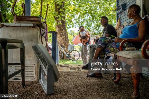 Yvette Johnson, who goes by Tootie, speaks with family outside of her home during a heatwave on July 21, 2022 in Houston, Texas. "Its too much heat...