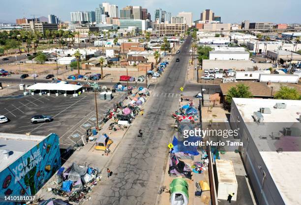 An aerial view of people walking past a homeless encampment in the afternoon heat on July 21, 2022 in Phoenix, Arizona. The National Weather Service...