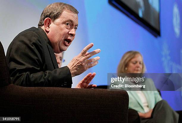 John C. Martin, chairman and chief executive officer of Gilead Sciences Inc., left, speaks while Meg Whitman, president and chief executive officer...