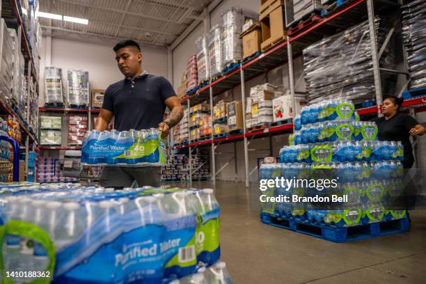Customer stocks up on bottled water in a Sam's Club during a heatwave on July 21, 2022 in Houston, Texas. Excessive heat warnings have been issued...