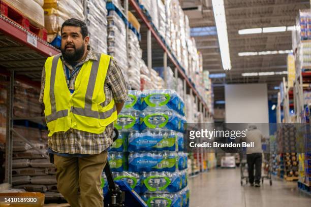 Sam's Club manager Carlos Limones restocks water during a heatwave on July 21, 2022 in Houston, Texas. "Our stocks of bottled water has completely...