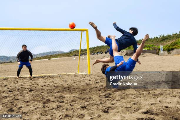 beach football player about to kick in the air - japan football archive stock pictures, royalty-free photos & images