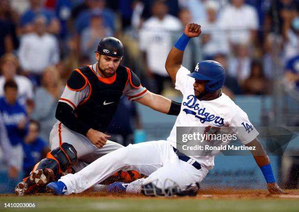 Hanser Alberto of the Los Angeles Dodgers scores a run against Austin Wynns of the San Francisco Giants in the second inning at Dodger Stadium on...