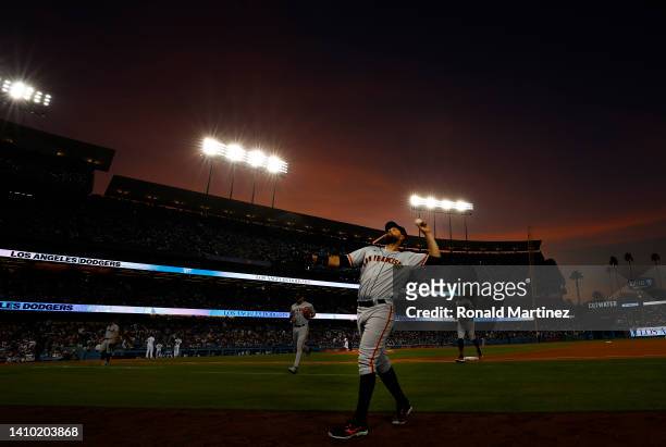 Brandon Belt of the San Francisco Giants throws a ball after the third out against the Los Angeles Dodgers in the third inning at Dodger Stadium on...