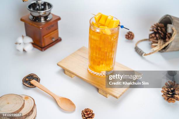 mango cocktail with white background - mango juice stockfoto's en -beelden