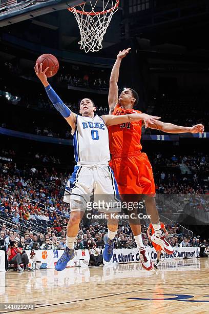 Austin Rivers of the Duke Blue Devils drives for a shot attempt in the first half against Jarell Eddie of the Virginia Tech Hokies in their...