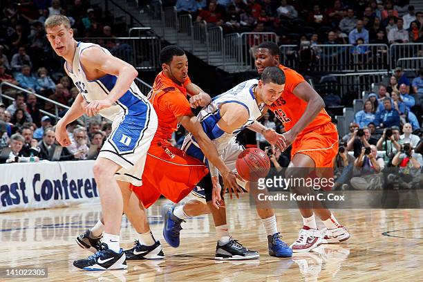 Austin Rivers of the Duke Blue Devils attempts to control the ball against C.J. Barksdale and Marquis Rankin of the Virginia Tech Hokies as Duke...