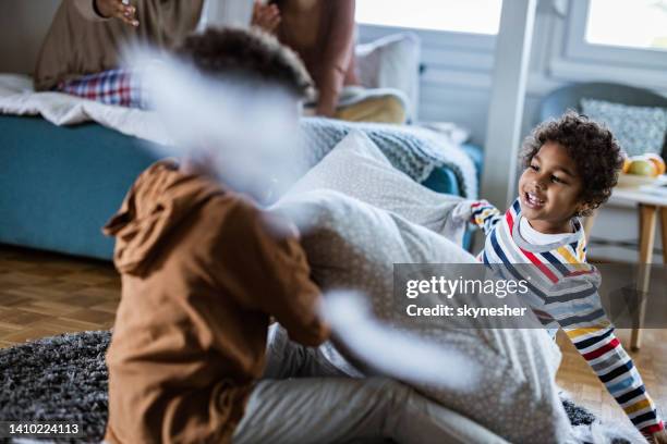 pillow fight! - sibling fight stock pictures, royalty-free photos & images