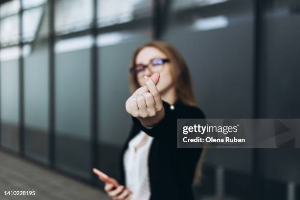 young woman snapping her fingers indoors. - clicking fingers stock pictures, royalty-free photos & images