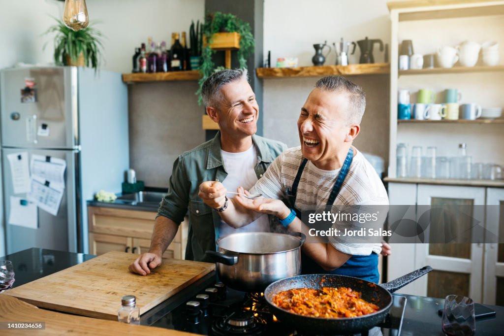 Gay couple having fun while cooking