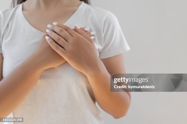 woman hands checking her breast - respiratory failure stock pictures, royalty-free photos & images