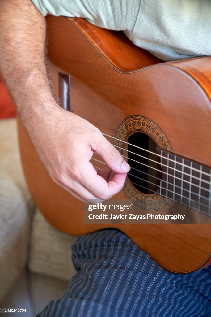 Unrecognizable Mid Adult Man Playing Acoustic Guitar