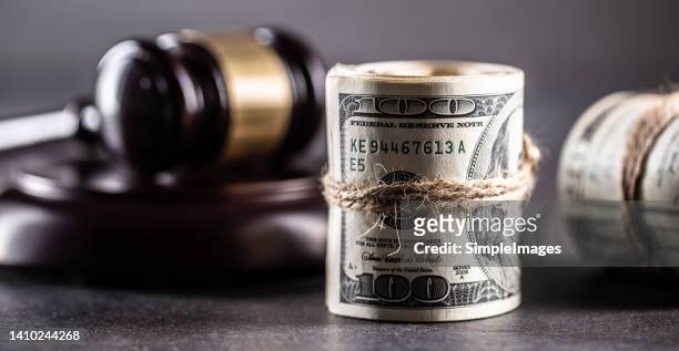 rolled american bills and judge's gavel, concept of corruption and bribery - money laundering fotografías e imágenes de stock