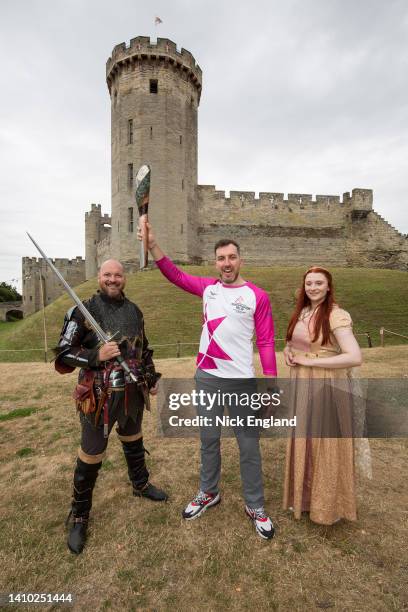 Batonbearer Jacob Balchin holds the Queen's Baton during the Birmingham 2022 Queen's Baton Relay at a visit to Warwick Castle on July 22 Warwick,...