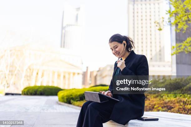 having video call in the park in front of the office - video reviewed stock pictures, royalty-free photos & images