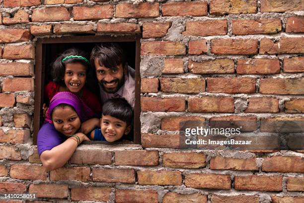 portrait of a family watching from window - the project portraits fotografías e imágenes de stock