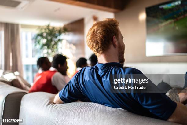sports friends fans watching a match at home - encouragement stock pictures, royalty-free photos & images