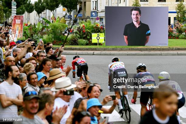 General view of the breakaway competing near a banner shows an image to pay tribute to Nicolas Portal, ex-pro cyclist and sports director of the Sky...