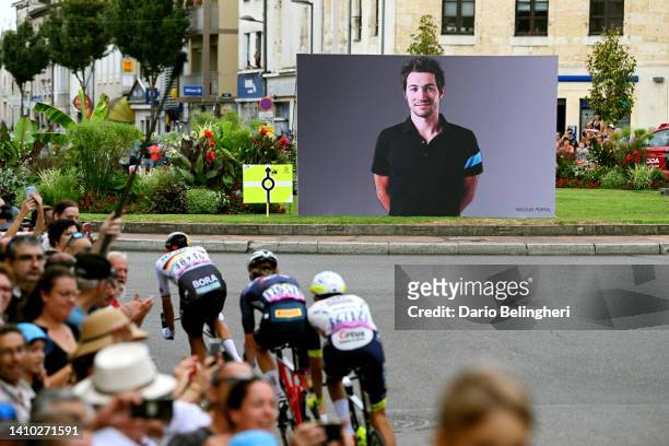General view of the breakaway competing near a banner shows an image to pay tribute to Nicolas Portal, ex-pro cyclist and sports director of the Sky...