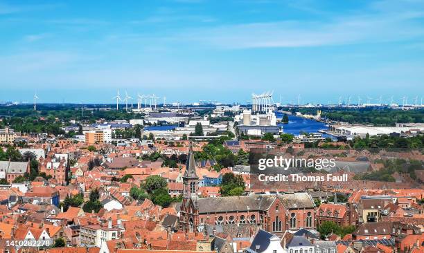 view over bruges to the commercial docks with wind turbines - west vlaanderen stockfoto's en -beelden