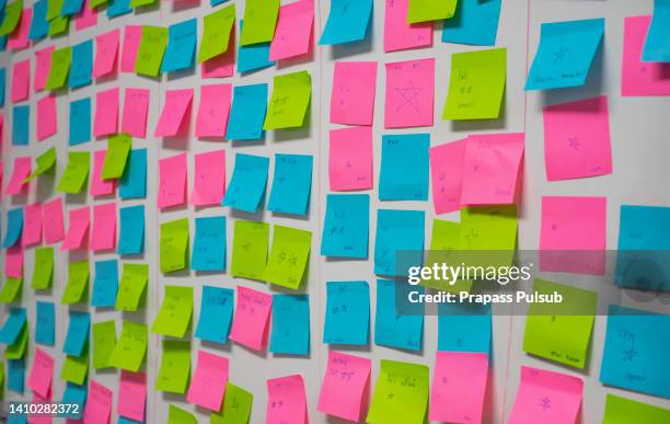 whiteboard post-it colored notes - wall of sticky notes stock pictures, royalty-free photos & images