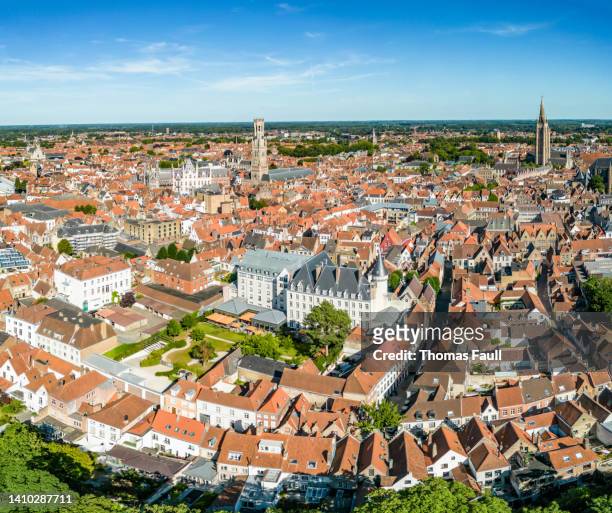 aerial view over bruges with belfry tower and church of our lady spires - bruges belgium stock pictures, royalty-free photos & images