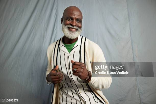 portrait of happy senior man dancing - beards jewellery london stock-fotos und bilder