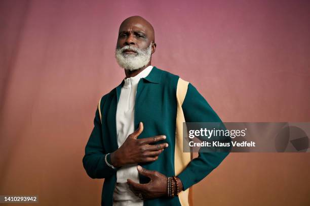 confident senior man against peach background - individuality fashion stock pictures, royalty-free photos & images