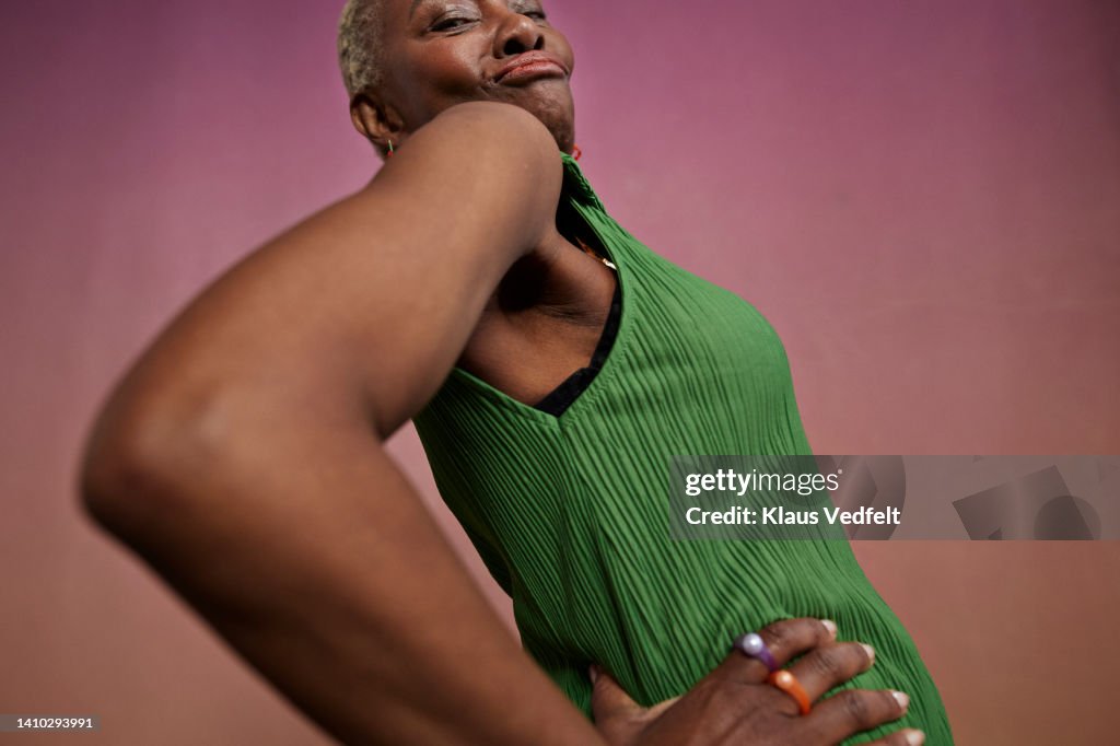 Senior modern woman dancing with hand on hip