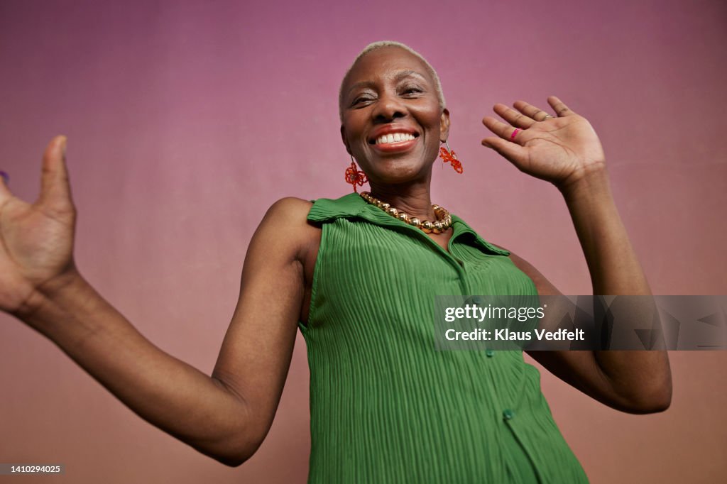 Portrait of joyful senior woman dancing