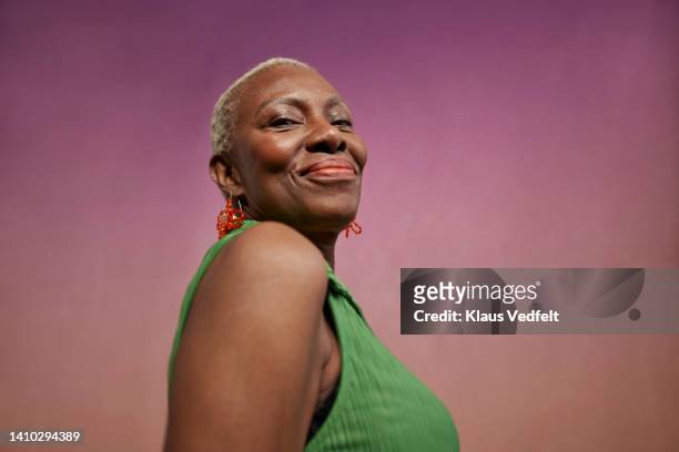 portrait of smiling modern senior woman - low angle view stock pictures, royalty-free photos & images