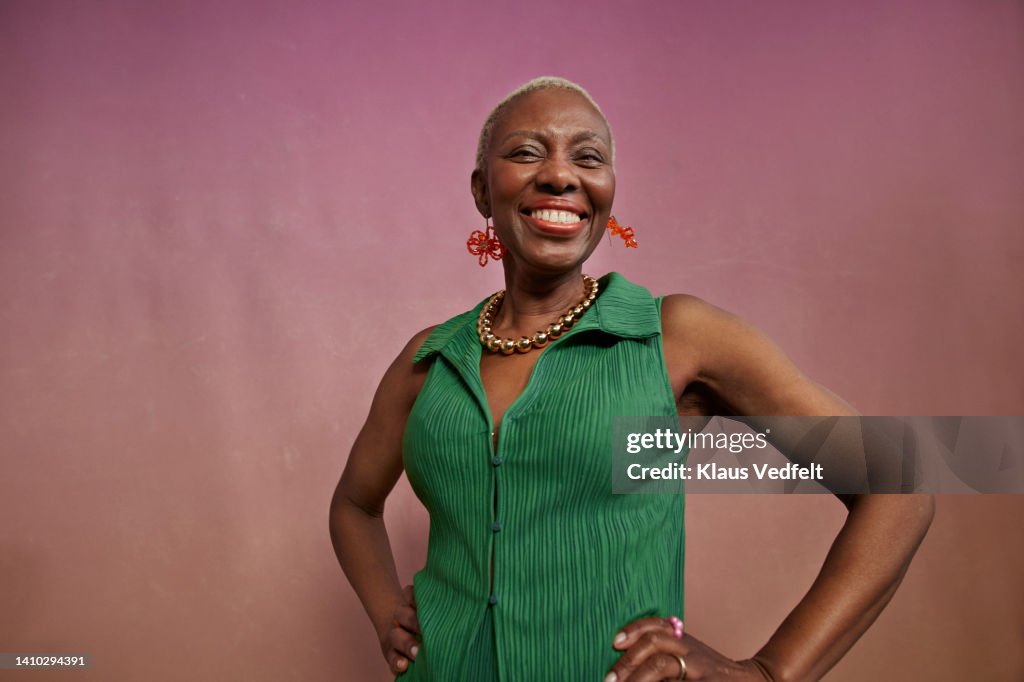 Portrait of elderly chic woman with hands on hips