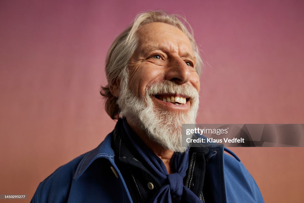 Smiling elderly man looking away