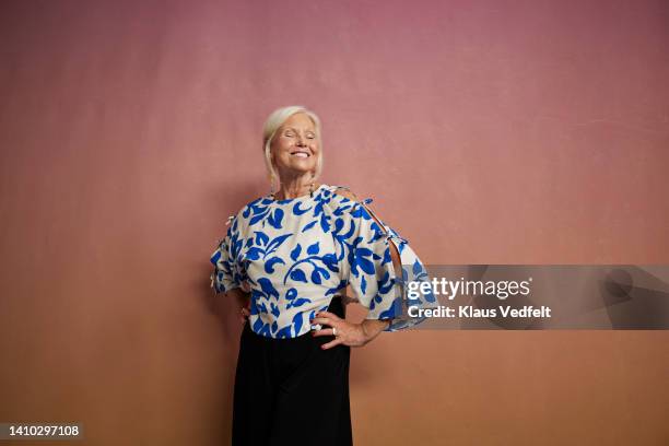 happy senior woman with eyes closed - hand on hip stock pictures, royalty-free photos & images