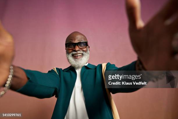 happy senior man with eyeglasses talking selfie - human limb stock pictures, royalty-free photos & images