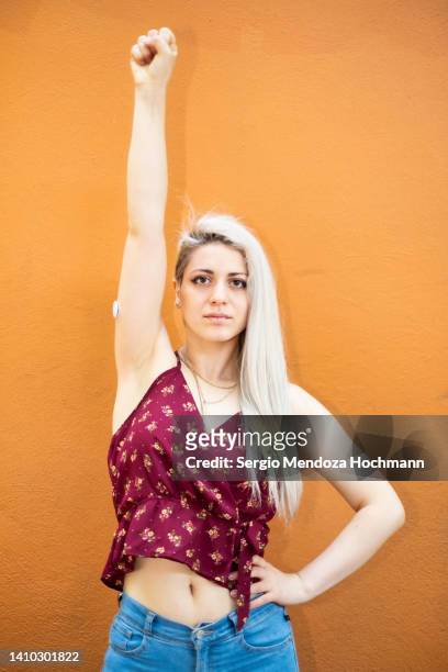 young latino woman looking at the camera, holding her hand up, platinum blonde hair - anti racism stock pictures, royalty-free photos & images