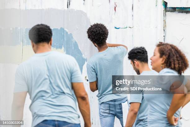 coworkers volunteer to help paint - cleaning graffiti stock pictures, royalty-free photos & images