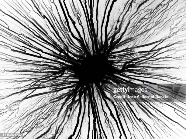 drop of black paint sliding on a blank canvas. - black watercolor stockfoto's en -beelden