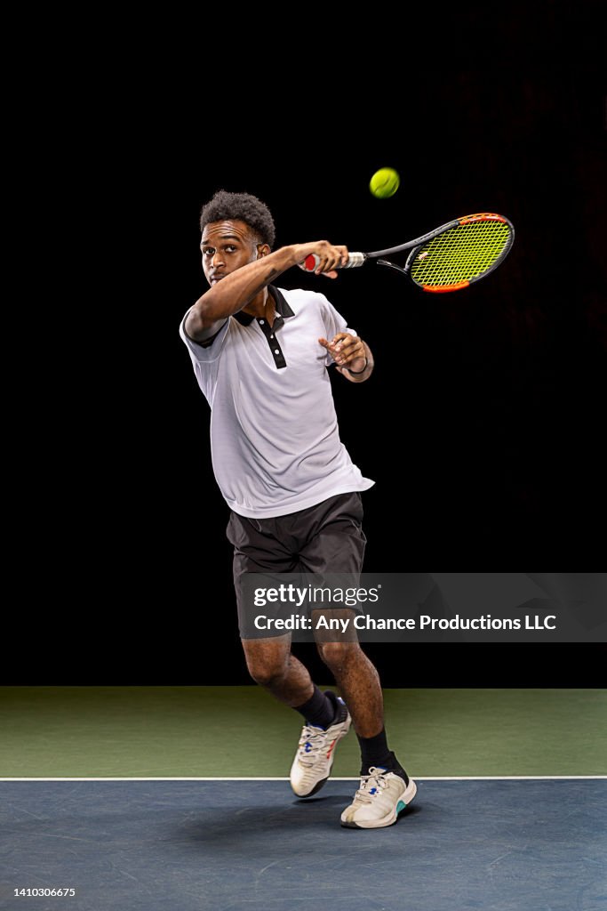 Tennis player hitting a forehand shot.