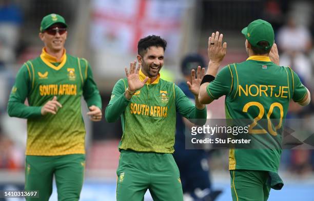 South Africa bowler Keshav Maharaj celebrates with Anrich Nortje after the pair combine to dismiss Moeen Ali during the 2nd ODI between England and...