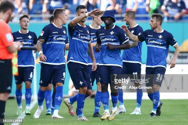 Braydon Manu of Darmstadt celebrates their team's first goal with teammates during the Second Bundesliga match between SV Darmstadt 98 and SV...