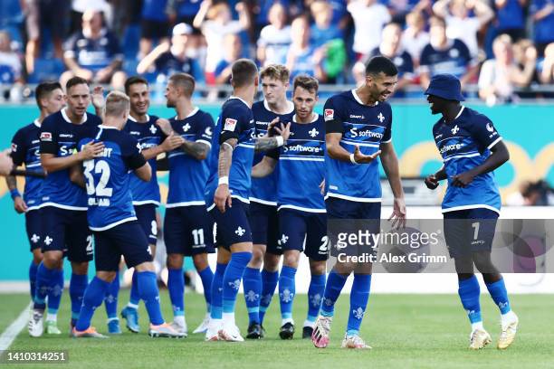 Braydon Manu of Darmstadt celebrates their team's first goal with teammates during the Second Bundesliga match between SV Darmstadt 98 and SV...