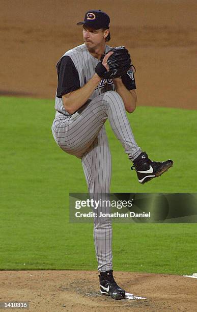 Randy Johnson winds up to deliver a pitch in the first inning during game five of the National League Championship Series between the Braves and the...