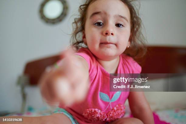 portrait of little girl at home touching the camera - child pointing stock pictures, royalty-free photos & images