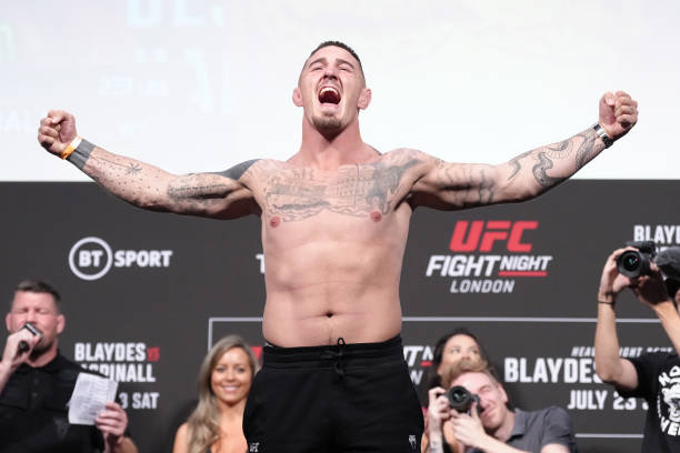 Tom Aspinall of England poses on the scale during the UFC Fight Night ceremonial weigh-in at O2 Arena on July 22, 2022 in London, England.