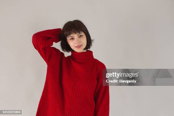 ragazza asiatica bruna in pullover rosso su priorità bassa bianca. bella modella in posa in studio. bob acconciatura. stile di moda. rossetto sulle labbra. donna adulta. sorridi sul viso - portraits studio smile foto e immagini stock