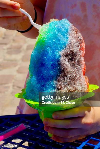 child enjoys a colorful snow cone - snow cone stock pictures, royalty-free photos & images